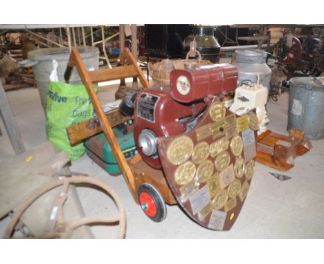 A BSA stationary engine on trolley together with a bag of cleaning rags; belt pulleys; a winch; two petrol cans; a water can;