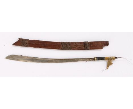 Early 20th Century Borneo miniature presentation Sarawak sword, the gilt brass grip above the white metal blade and scabbard,