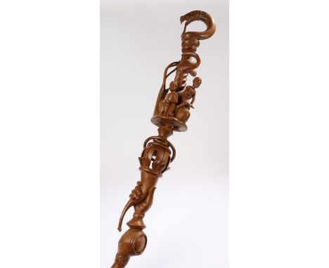 African carved walking stick, with a coiled snake above figure playing musical instruments and a hand holding a torch, 109cm 