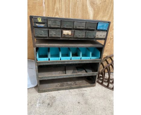 A VINTAGE TOOL STORAGE UNIT WITH UPPER INDIVIDUAL TRAY DRAWERS AND LOWER SHELVES 