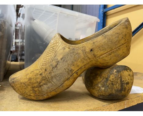 A LARGE PAIR OF VINTAGE WOODEN CLOGS 