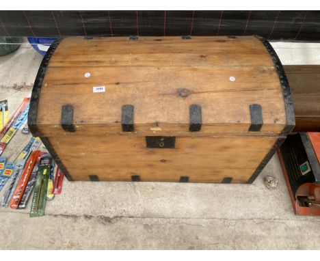 A VINTAGE PINE AND METAL BOUND TRAVEL TRUNK 