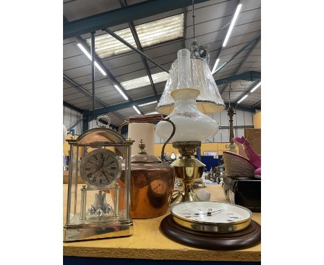 A LARGE COPPER KETTLE, BRASS AND GLASS OIL LAMP CONVERTED TO ELECTRICITY, AN ACCTIM MANTLE CLOCK AND A WALL CLOCK 