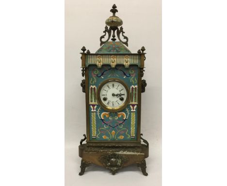 AN ART NOUVEAU CLOISONNE AND BRASS CHIMING MANTLE CLOCK WITH RAM HEAD SIDE DESIGN 