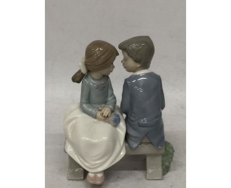 A NAO LLADRO OF A GIRL AND BOY ON A BENCH 