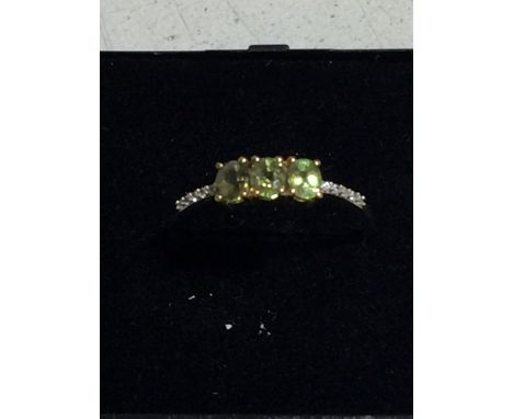 A 9CT GOLD RING WITH 3 PERIDOTS AND DIAMONDS WEIGHT 1.8G SIZE R AND A HALF 