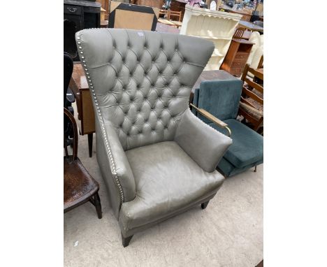A MODERN GREY LEATHER WINGED, STUDDED AND BUTTON-BACK FIRESIDE CHAIR 