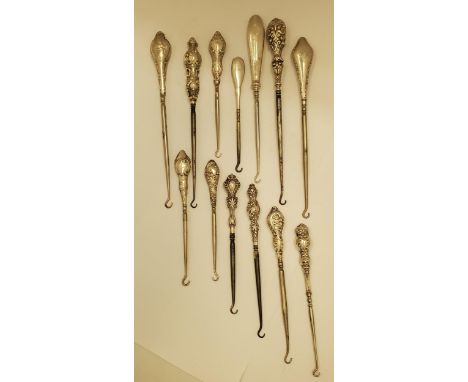A COLLECTION OF THIRTEEN VICTORIAN AND LATER SILVER HANDLED BUTTON HOOKS 