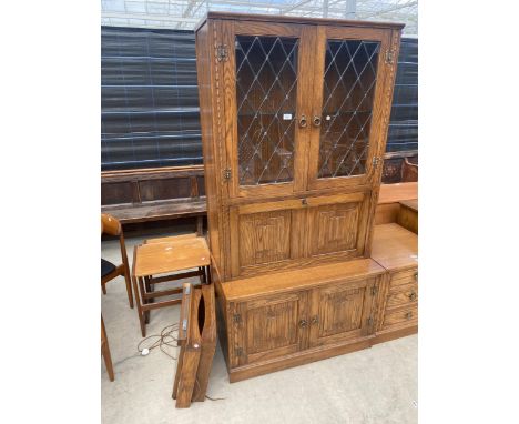 A JAYCEE OAK TWO DOOR GLAZED AND LEADED COCKTAIL CABINET COMPLETE WITH WALL SHELF, 36" WIDE 