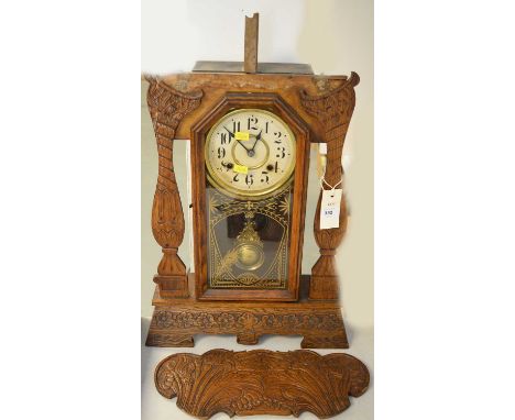 An American oak pendulum clock, by the New Haven Clock Co, USA, with foliate carved case (top loose though present).