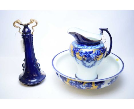 An F.W. &amp; Co ‘Floral’ blue, white and gilt decorated ewer and basin, the ewer 29cms high; together with a twin-handled va