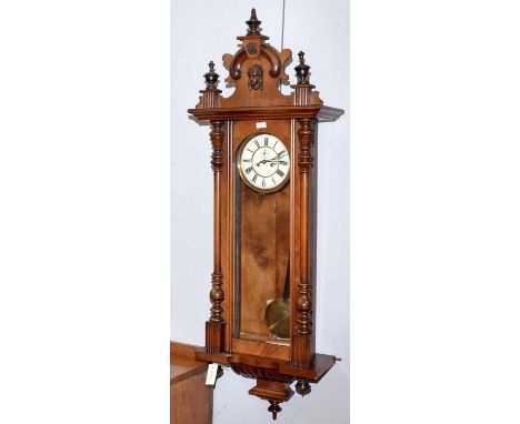 A walnut Vienna-style clock, circa 1900, with enamelled roman dial, subsidiary seconds dial, the architectural case with deco