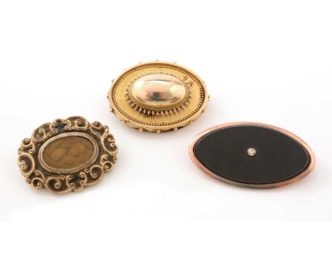 A Victorian gold oval brooch, with beadwork design, hair plait to reverse (tests as 14ct yellow gold), 10.4g gross; a gold an