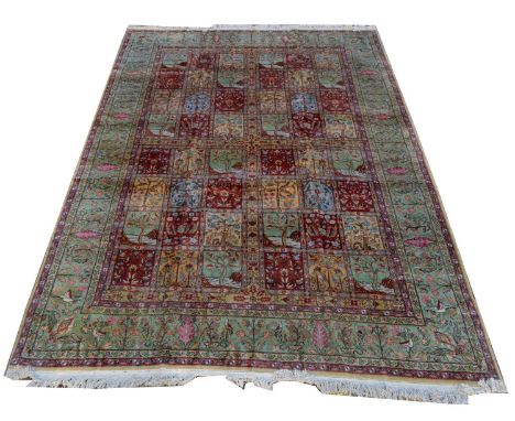 A Qum carpet, with floral panels, 370 x 272cms.