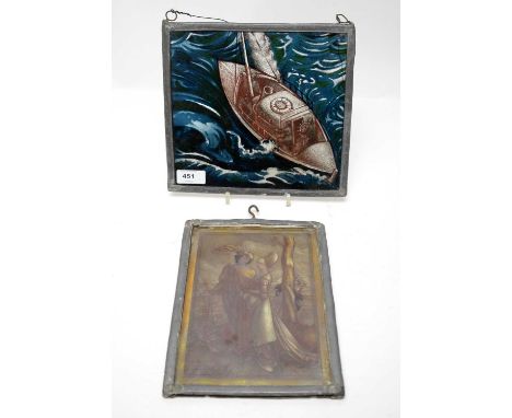A 19th Century reverse painted lead cased glass panel, illustrating a ship at sea, 21 x 23cms; together with another stained 