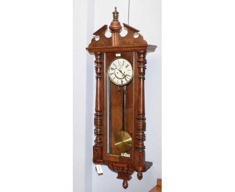 A walnut Vienna-style wall clock, c 1900, with enamelled roman dial, subsidiary seconds dial, in architectural case with turn