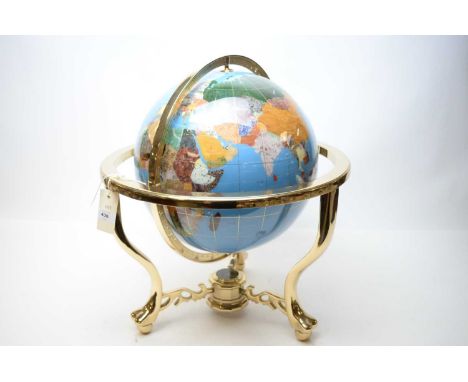 A specimen stone globe, on gilt metal stand, with three cabriole legs joined by a compass set undertier, approximately 47cms 