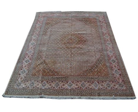 A Tabriz carpet, the diamond-shaped medallion and field with flowerhead design, 398 x 292cms.