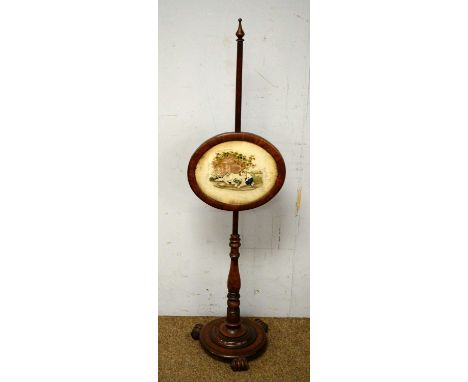 A 19th Century mahogany pole screen with oval needlework panel with sleeping boy and dog, turned standard supports, circular 