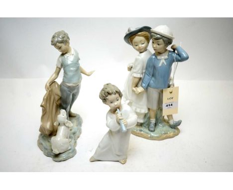 Lladro figure group of a boy and girl, 26cms high; together with a Nao figure of a boy and puppy; and a Lladro cherub. (3)