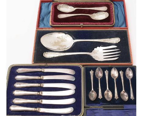 A pair of silver preserve spoons, in fitted case; a set of six silver coffee spoons, cased; a set of six tea knives with silv