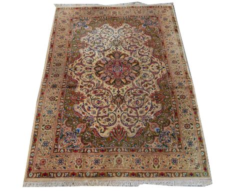 A Tabriz carpet, the floral rosette and scrolls to fields on ivory-coloured ground, 300 x 200cms.