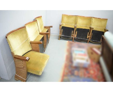 Two sets of three Art Deco folding Cinema seats, each with gold coloured upholstery, mahogany arm rests and top rail, each tr