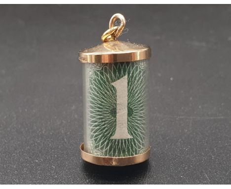 A VINTAGE 9K GOLD CHARM/PENDANT WITH A £1 NOTE FOLDED INSIDE THE CAPSULE.2.9gms    2cms 