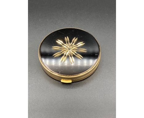 Vintage Helena Rubenstein compact having black enamel mirrored lid with gold tone inlay. 