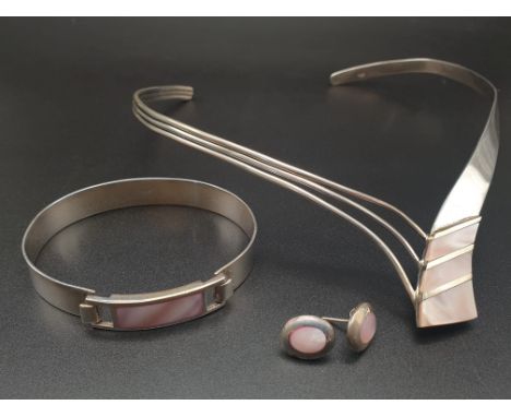 A modern sterling silver (stamped 925) and pink mother of pearl necklace, bangle and earrings set designed by the accomplishe