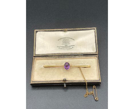 Antique 15 Carat Gold bar brooch late 19th early 20th century, having large oval amethyst centre stone .Gold safety  chain ,p