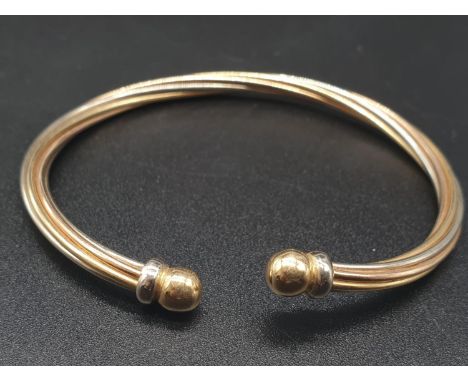 18K Yellow Gold Bangle with Twist Decoration. 6.5cm Diameter. 13.45g 