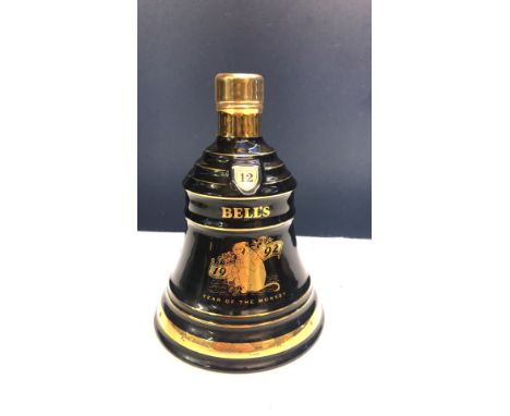 A Wade porcelain decanter, "Year of the Monkey" 1992 edition, features gold accents.