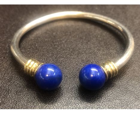 Silver child's bangle with yellow metal collars & blue enamel Weight 20g