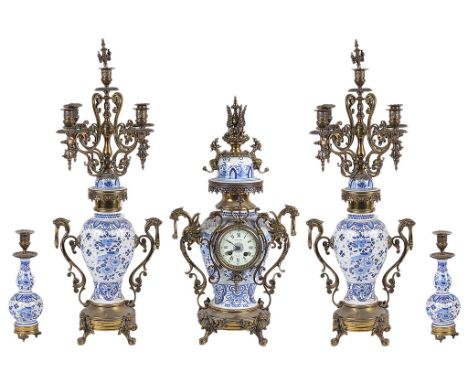 A Dutch Clock Five-piece Garniture:A Clock, Candelabra and Candlestick set, the Delftware bodies with gilt brass fittings, th