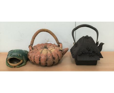 An Oriental terracotta pumpkin teapot; together with a cast-iron teapot and frog