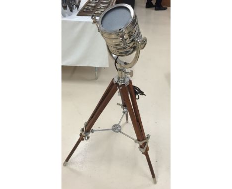 A tripod lamp with adjustable searchlight