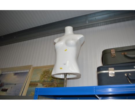 A female mannequin torso on stand