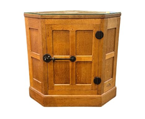 A Robert 'Mouseman' Thompson of Kilburn, North Yorkshire oak floor standing corner cabinet, with panelled door and sides, wit