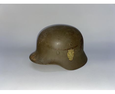 A military green coloured steel helmet of German design with Norwegian decals and leather chin strap