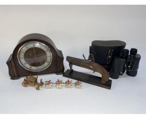 An early 20th Century oak mantle clock of domed outline, 24cm H, a Crescent Toys Royal State Coach, an ornamental flintlock p