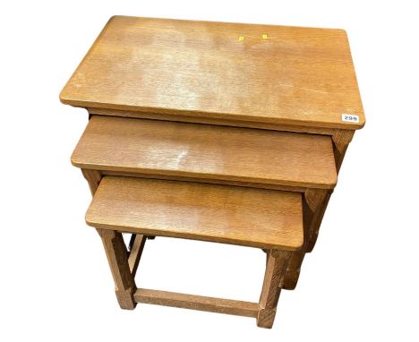 A Robert 'Mouseman' Thompson of Kilburn, North Yorkshire nest of three oak tables, with carved mouse to one leg of each table