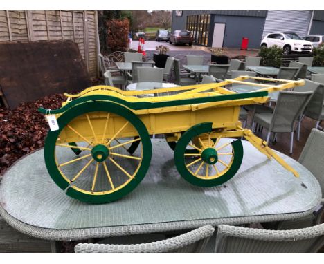 A SMALL SCALE HAY CART , PROBABLY FOR A DOG.