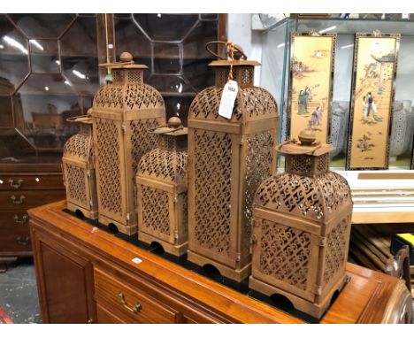 TWO TALL AND THREE OTHER PIERCED IRON CANDLESTICK LANTERNS