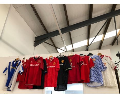 A INTERESTING COLLECTION OF VINTAGE MANCHESTER UNITED FOOTBALL SHIRTS. DATING FROM EARLY 80's THROUGH 90's, MAINLY UMBRO AND 