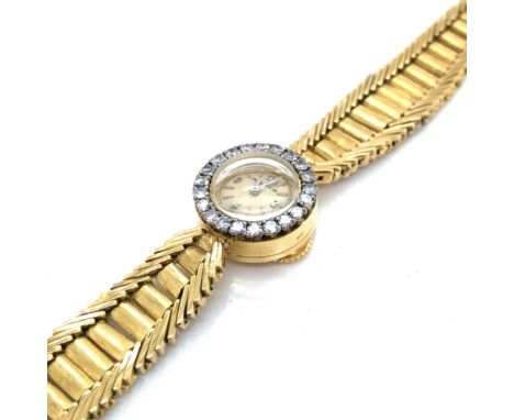 A VINTAGE JAEGER-LE COULTRE LADIES WRIST WATCH WITH A DIAMOND SET BEZEL. THE WINDER BUTTON POSITIONED TO THE REVERSE OF THE W