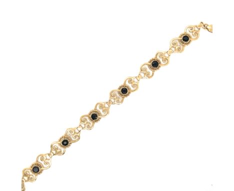 A VINTAGE SAPPHIRE OPENWORK PANEL BRACELET. NO ASSAY MARKS, THE TRIGGER CLASP STAMPED 375, ASSESSED AS 9ct GOLD. LENGTH 19cms