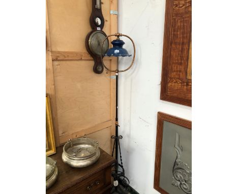 A WROUGHT IRON AND COPPER ADJUSTABLE STANDARD LAMP WITH A BLUE GLASS SHADE