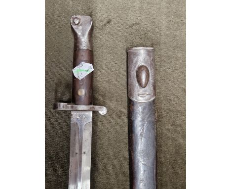 A SANDERSON OF SHEFFIELD DOUBLE EDGED BAYONET WITH IRON MOUNTED LEATHER SCABBARD, THE OVERALL LENGTH.   44cms.