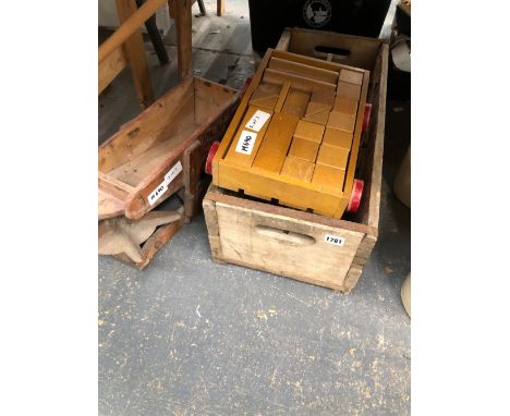 A VINTAGE CHILDS BRICK TROLLEY A ANTIQUE SEED DISTRIBUTOR AND A WOODEN BOTTLE CREATE 
